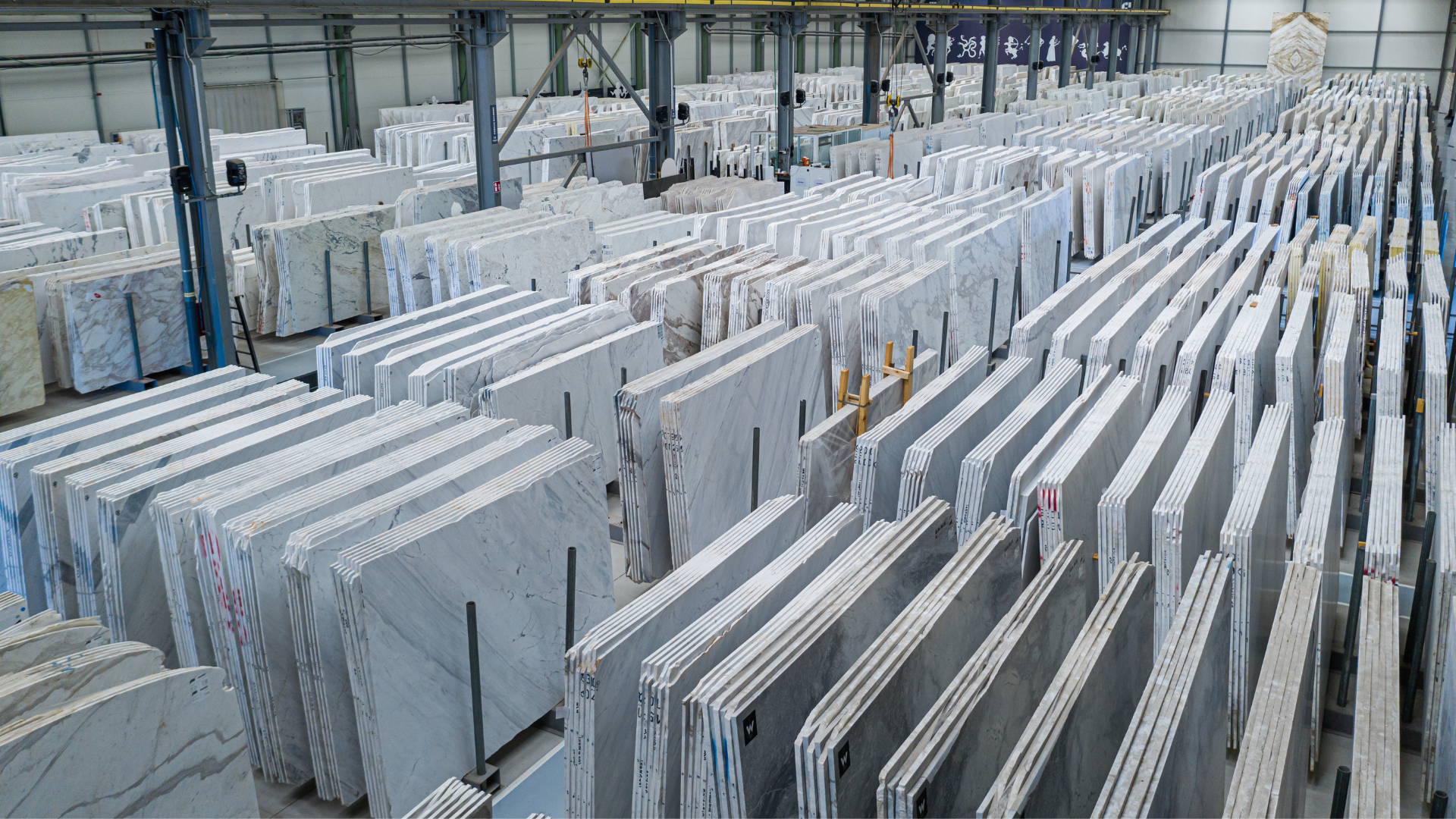 Indoor warehouse with marble slabs stored from Stone Group International’s facilities