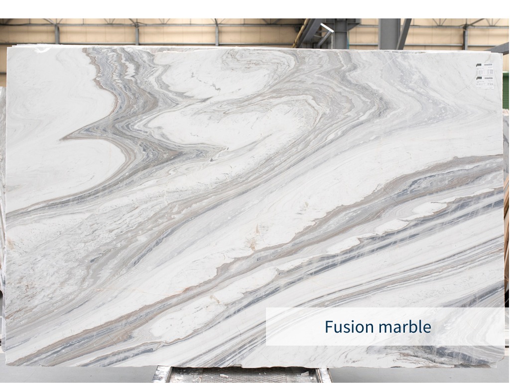 Slab of the white Greek marble Fusion with bold veins on its surface and placed in an indoor warehouse of a natural stone supplier