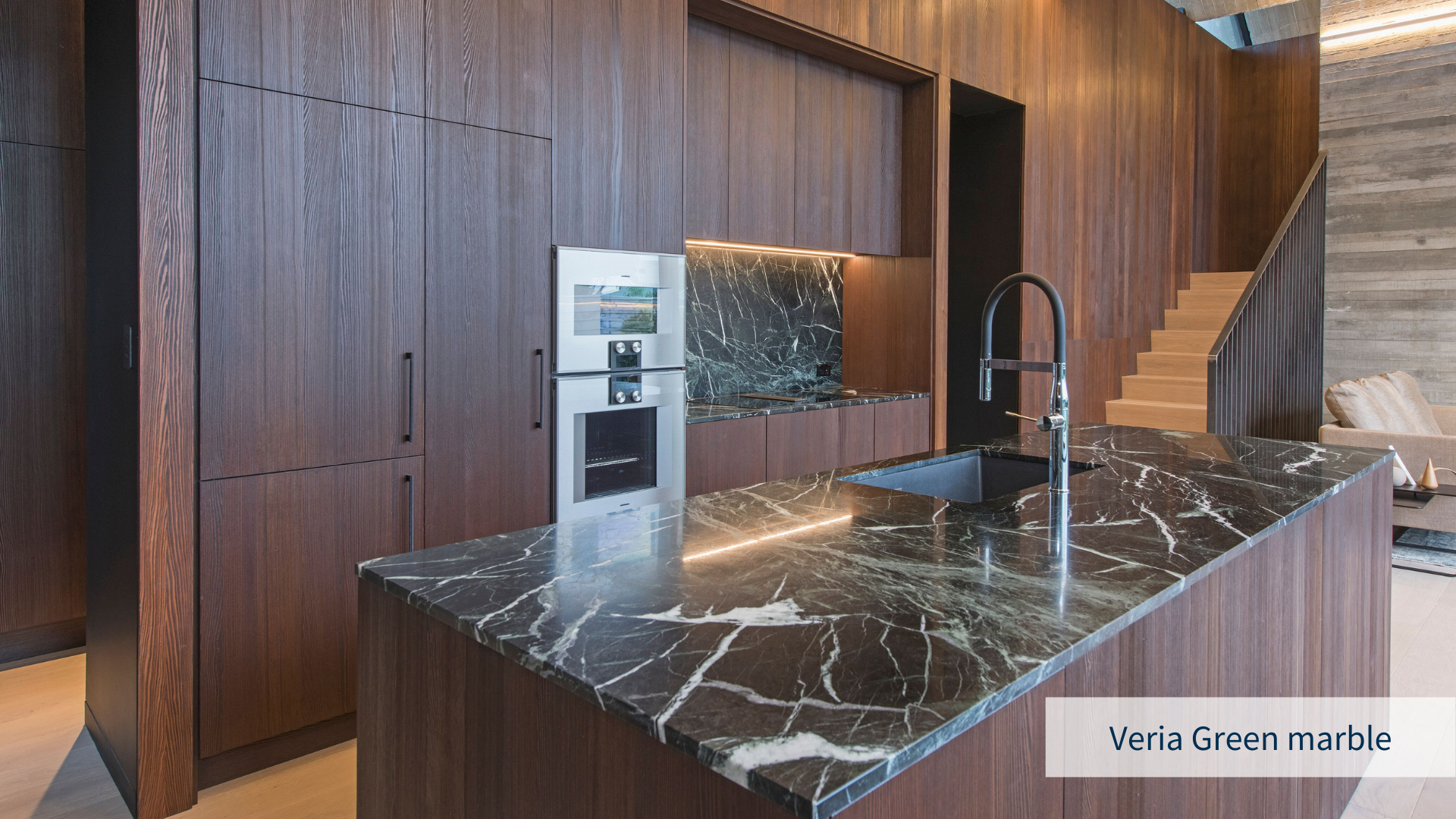 Luxurious kitchen rendering with veria green marble countertop and backsplash and dark wooden cabinets