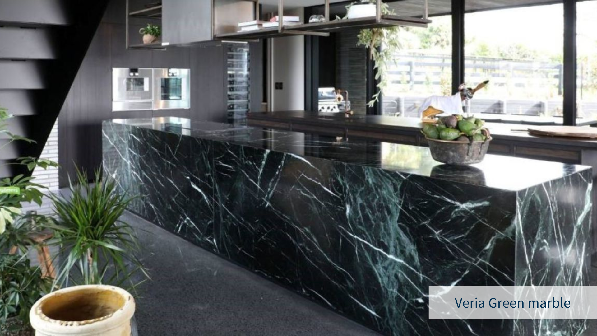 Modern kitchen rendering with veria green marble countertops, combined with dark wood in the cabinets and green elements, plants and minimal decor